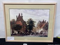 Full front view of framed art print showing a historical town hall and market scene.