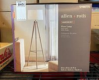 Box front showing a photo and details of Allen & Roth Amesbury floor lamp in gray finish with white shade.