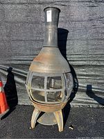 Front view of metal chiminea with mesh door closed