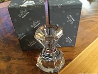 Clear heavy crystal Rosenthal candle holder with original black branded box, shown on wooden surface.