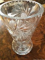 Clear lead crystal vase with detailed pinwheel cuts and heavy base shown from top angle