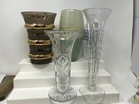 View of all five vases showing various sizes and styles: crystal cut designs, gradient opaque, retro gold-banded