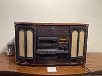 Front view of the TEAC audio system showing speakers, cassette deck, and control panel.