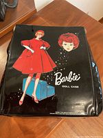 Closed black vinyl Barbie Doll Case with female figure graphic