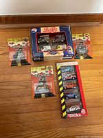 Top-down view showing Pepsi-Cola car set, Cycle Town motorbikes in packaging, and Tonka Big 5 set.