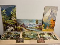 Full view of all seven art prints showing different mountain and village scenes