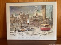Full view of framed art print showing Toronto's Old City Hall, vintage cars, and a red streetcar on a snowy street.