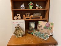 Photo showing the nature-themed decorative lot items arranged on a wooden surface with shelf in background.