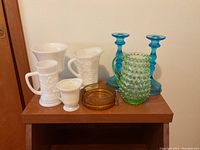 Lot overview showing all glassware items grouped together on a wooden surface.