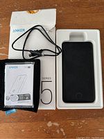 Photo showing Anker Power Bank packaging, carry case, USB charge cord, and included instructions.