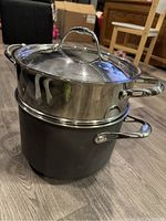 Photo of the pot stacked with the steamer insert and lid on top, showing overall set appearance and handle design.