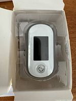 Fingertip pulse oximeter device in original plastic packaging inside box