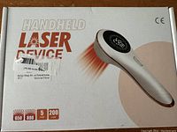 Box showing the handheld laser device with specifications including 650 nm and 808 nm wavelengths, 5 mW and 200 mW power ratings.