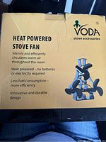 Box with front branding and product features including heat powered fan that circulates warm air silently without batteries or electricity.