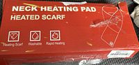 Photo of original packaging box for neck heating pad heated scarf with icons showing heating scarf, washable and rapid heating features
