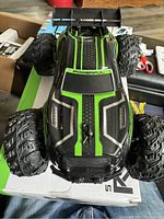 Top view of the Storm RCS remote control off road race car showing green and black design and 'POWERFUL' text.