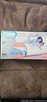 Box showing Aerobed Premier Comfort Zone queen size air mattress with feature illustration and couple lying on mattress.