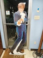 Full frontal image of the Austin Powers stand up display, showing the character in blue velvet suit with finger gun pose.