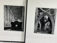 Two framed black and white photos showing cathedral interiors with detailed Gothic architecture, side by side in a standing position.