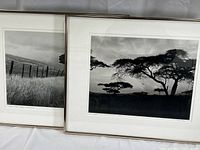 Two framed black and white 11x14 photographic prints leaning against white background showing overall framing and side by side arrangement.
