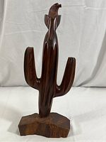Full view of the hand carved wooden Saguaro cactus sculpture with eagle perched on top, shown against white backdrop.