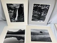 Four black and white landscape photographic prints mounted on white mats, showing different scenes including Yosemite Valley and other landscapes.