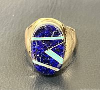 Front view showing oval lapis stone with turquoise inlay on sterling silver band.