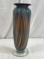 Full view of tall cylindrical glass vase showing swirling striped colors in taupe, tan, and blue, standing 12 inches tall.