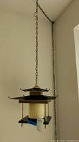 Lamp hanging from ceiling by chain showing full pagoda design