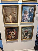 Full view of all four framed prints arranged on wall, showing overall size and frame style