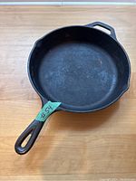 Top-angle view of the Lodge cast iron frying pan showing the interior surface with some discoloration and wear marks.