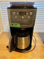 Front view of the Cuisinart coffee maker showing control panel, digital display, and stainless steel thermal carafe.