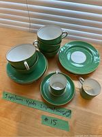 Full set of Aynsley fine china items including cups, saucers, plates and espresso cups with saucers displayed on table with label showing quantities.