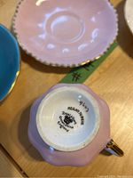 Pink Royal Albert teacup base showing brand marks and gold handle detail