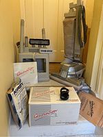 Full setup including Kirby vacuum, shampoo system boxes, accessory case with heads and attachments on floor