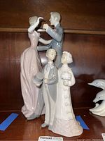 Photo showing both Lladro figurines side by side on shelf.