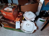 Photo showing two Corning Ware Blue Cornflower covered baking dishes, a percolator carafe and Corning covered baking dish boxes.
