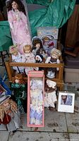 Full view of the eleven dolls in a wooden rack and surrounding area.