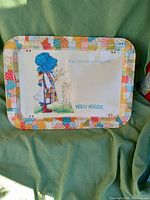 Full view of vintage 1972 Holly Hobbie metal serving bed tray with character illustration and patchwork border.