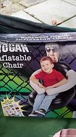 Box showing Hollywood Hulk Hogan Inflatable Chair with child model sitting on it.