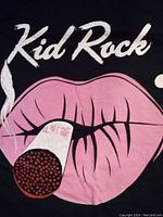 Close-up of front graphic showing pink lips holding a lit cigarette with smoke and 'Kid Rock' text above.
