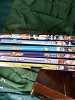Photo showing a stack of Shonen Jump magazines dated from 2007-2008 with colorful spines and manga character artwork.