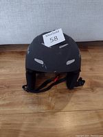 Front angled view of the black Bollé helmet showing wear and scratches