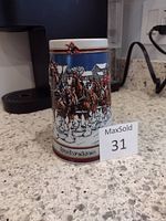 Right side view of Budweiser stein showing horse-drawn wagon scene with snowy background and Budweiser logo at bottom.