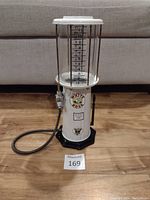 Frontal view of miniature White Rose gas pump replica showing logo, hose, and meter markings