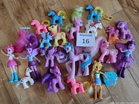 Full lot showing entire My Little Pony collection of 20 figures and dolls on wooden floor