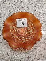 Top view of Northwood Strawberry Bowl showing ruffled edge, iridescent merigold finish, detailed raised strawberry and leaf pattern.