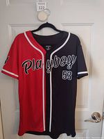 Front view of Playboy shirt/jersey showing red and black split colors, white trim and text "Playboy 53"