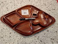 Photo of the wood serving bowls nested together showing their shapes and finish, with a Sharpie for scale.