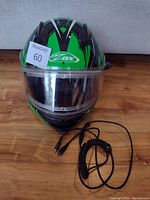 Front view of ZOX helmet with visible visor and included black coiled cable.